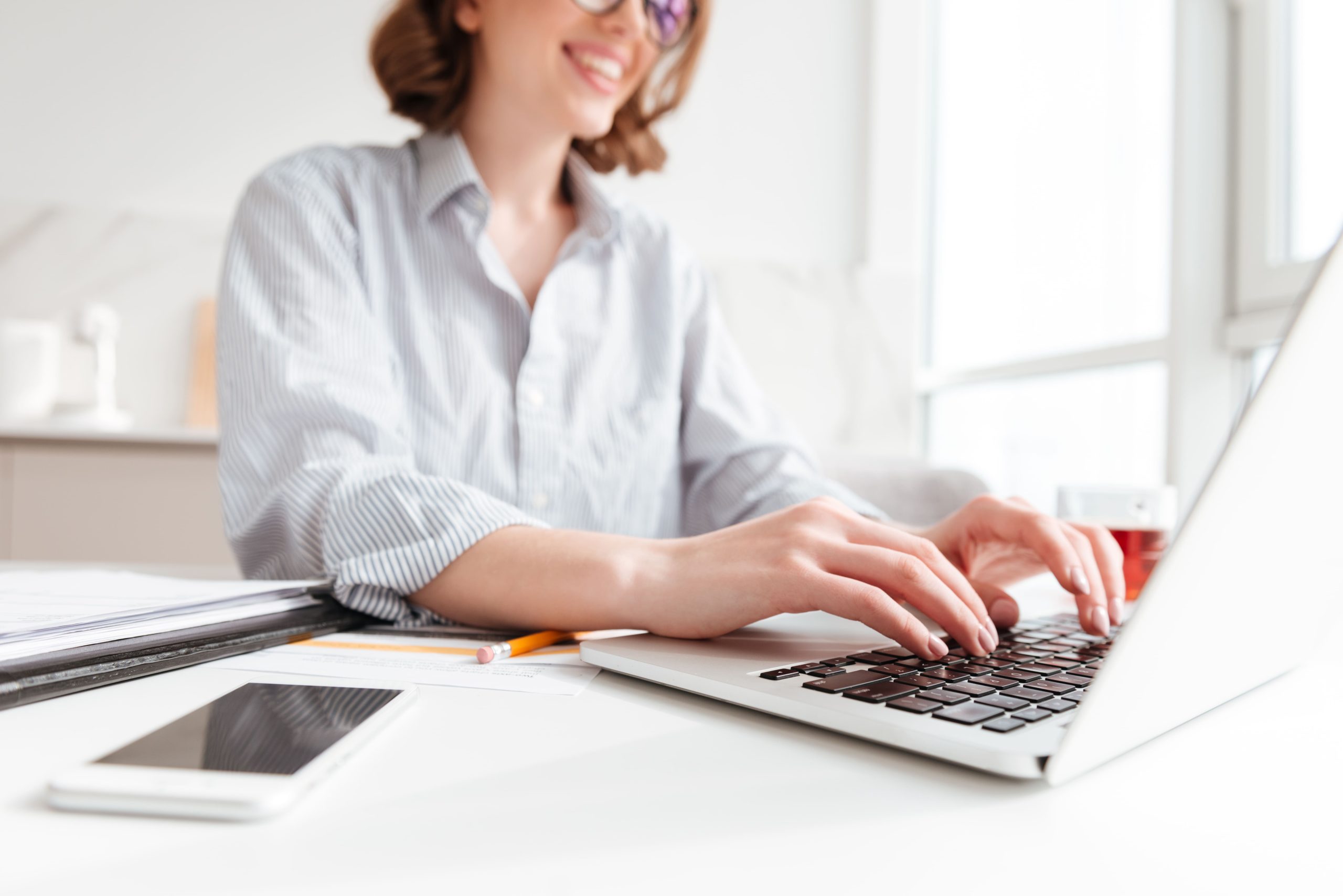 brunette-woman-typing-email-laptop-computer-while-sitting-home-selective-focus-hand (1)